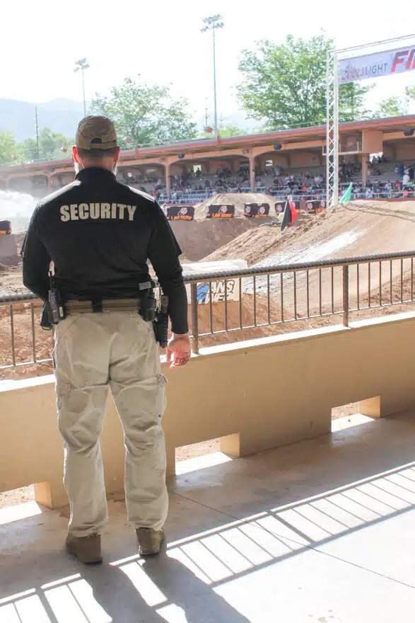 photo of the back of a security guard looking at event