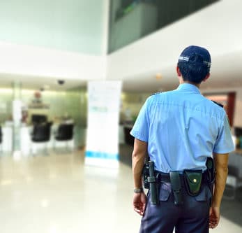 The image shows a security guard patrolling a bank.