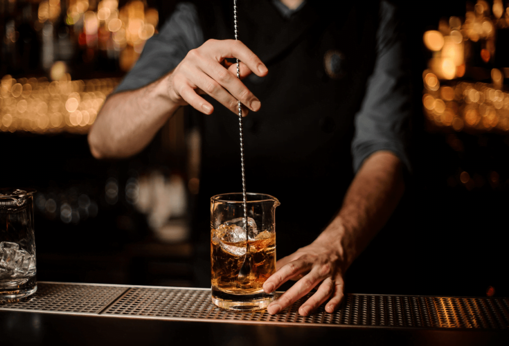 Closeup of a bartender stirring a cocktail