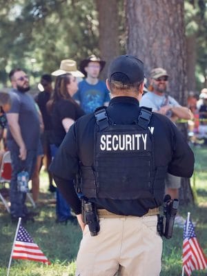 Event security guard standing supervising event patrons