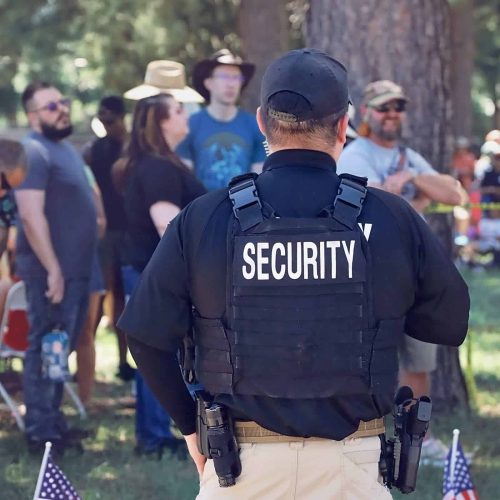 Event security guard standing supervising event patrons